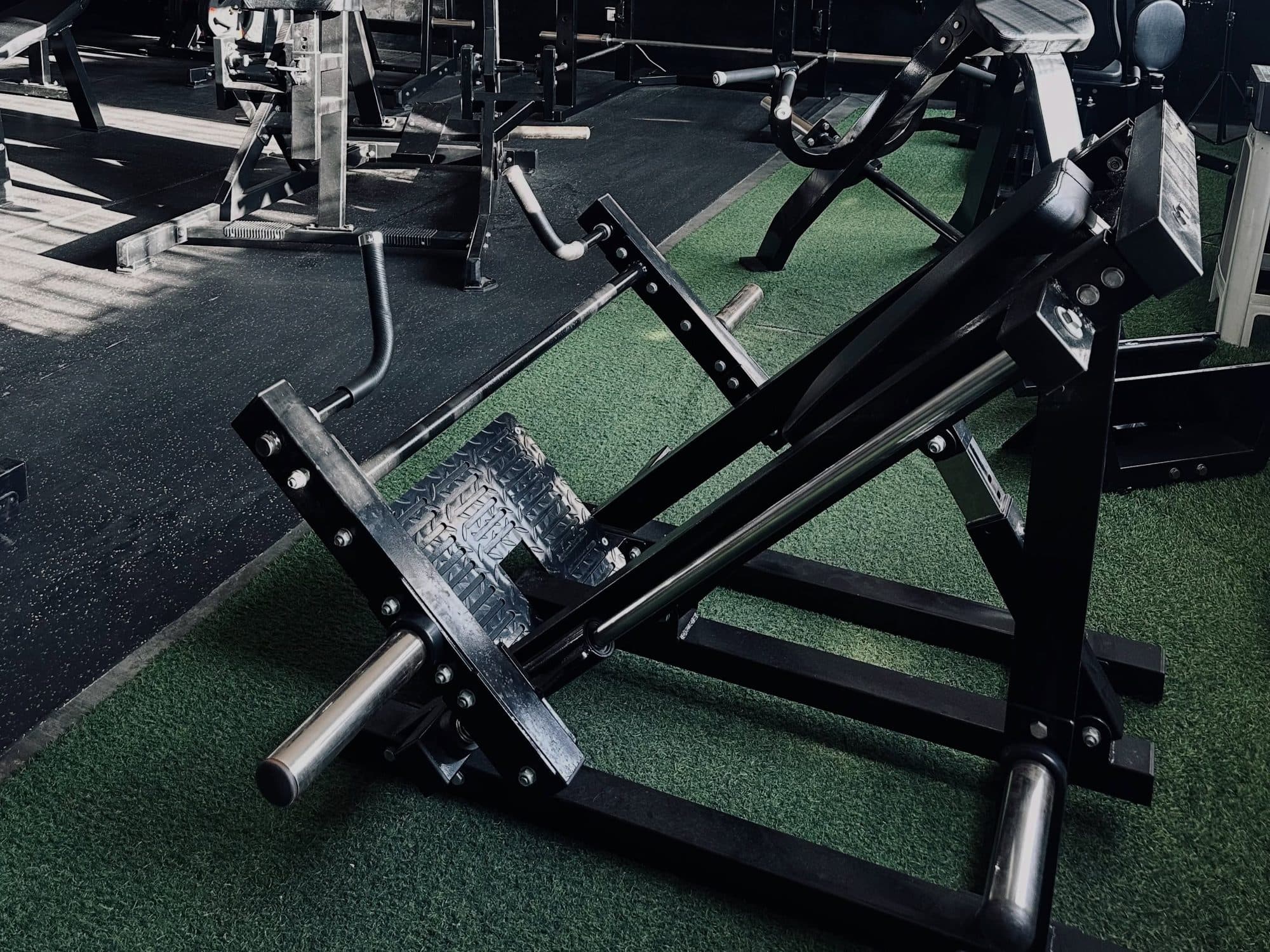 Leg press and hack squat machines on the turf floor