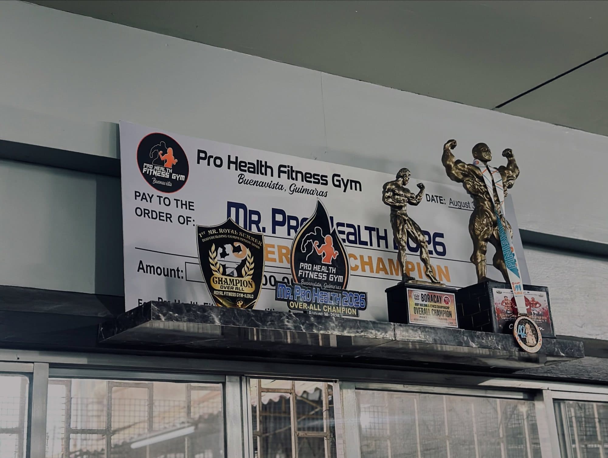 The Mr. Pro Health overall champion trophies and plaque