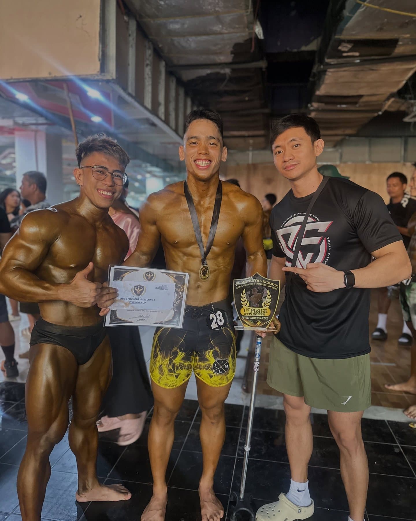 Three Project-E athletes with a trophy and a certificate